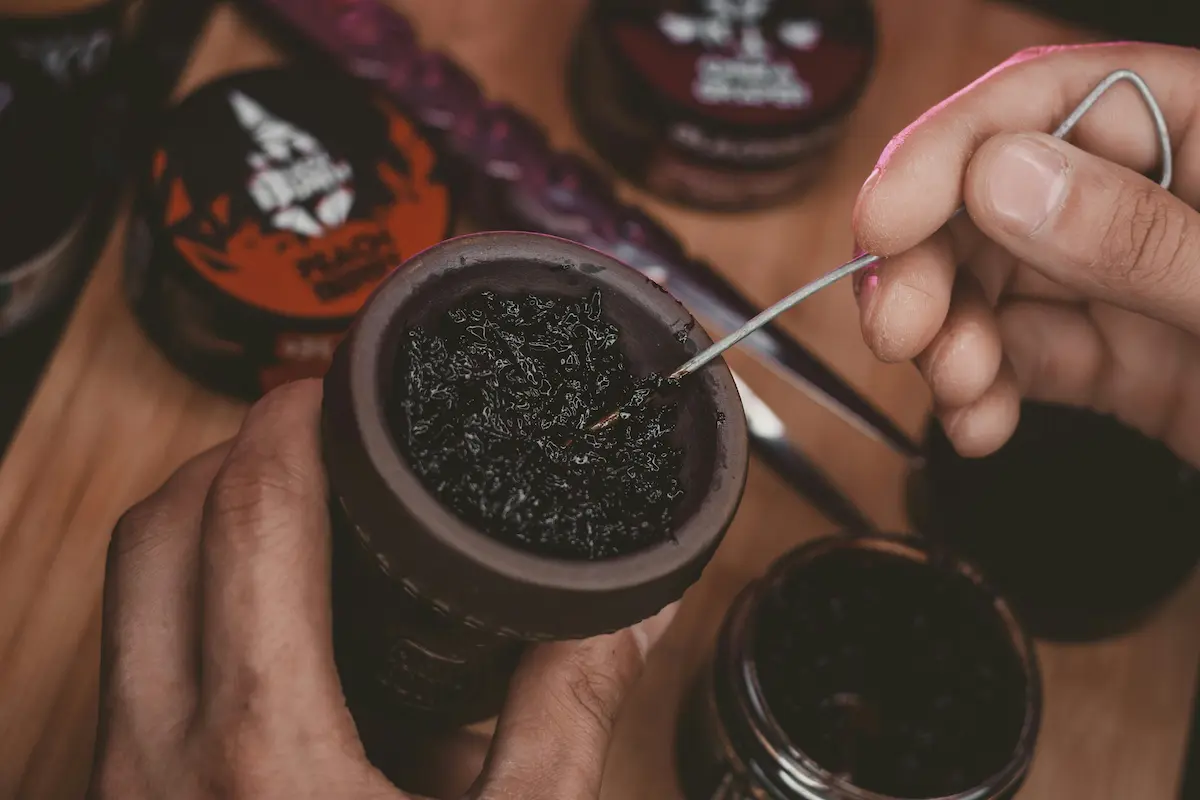 Shisha-Kopf wird mit Tabak befüllt